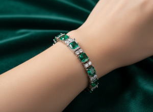 Macro close up of a natural emerald and diamond line bracelet clasped on a wrist